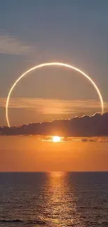 Vibrant sunset with ocean and celestial ring.