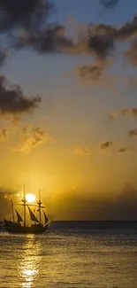 Silhouette of a ship against a golden sunset over the ocean.