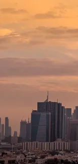 City skyline at sunset with an orange sky backdrop.