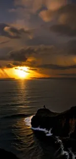 Sunset over an ocean with clouds and cliffs in warm, golden hues.