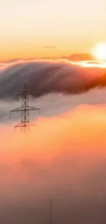 Sunset over clouds with an electricity pylon and vibrant orange hues.