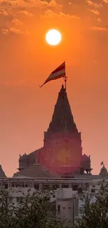 Sunset over a temple with an orange sky and silhouette effect.