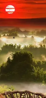 Vibrant sunset over misty forest landscape with reddish hues.