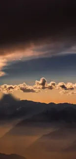 Mountain sunset with dramatic clouds and a serene landscape.