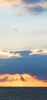 Vibrant sunrise with clouds over the ocean horizon.