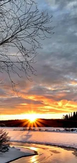 Sunset over a snowy river with golden reflections.