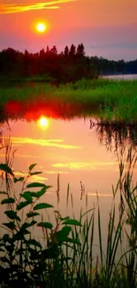 Beautiful sunset reflecting on a tranquil lake with lush greenery.