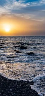 A breathtaking sunset over a tranquil ocean with a rocky shoreline.