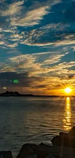 Stunning sunset over blue waters and clouds with golden reflections.