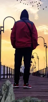 Silhouetted figure on a pier at sunset with a dramatic sky.