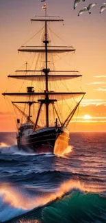 Tall pirate ship sailing against a stunning orange sunset over the ocean.