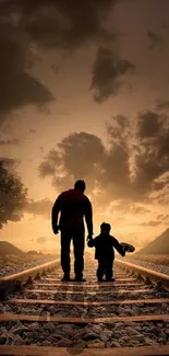 Father and child walking on railway at sunset, surrounded by dramatic landscape.