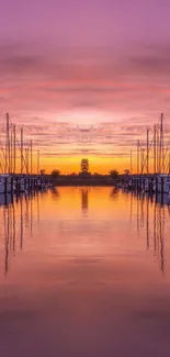 Purple sunset over marina with boats reflecting on calm waters.