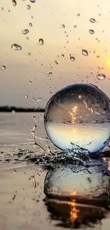 Crystal sphere with sunset reflection and water splash.