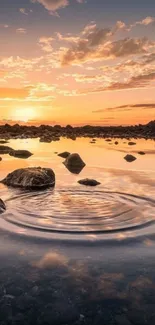 Sunset reflection over calm water with rocks and clouds.