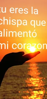 Hand holding the sun with text over ocean sunset scene.