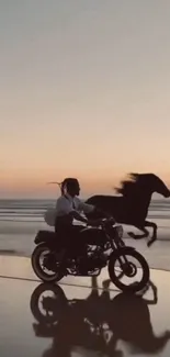 Motorcyclist and horse on beach at sunset.