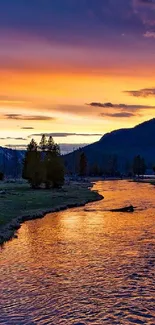 Orange sunset over river and mountains in nature scene