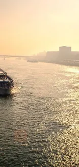 Golden sunset over a river with a boat sailing peacefully.