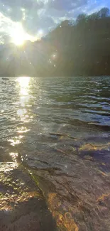 Peaceful river at sunset with sunlit water reflections and natural scenery.