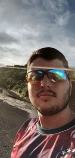 Scenic road selfie at sunset with nature backdrop.