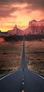 Sunset road leading to red mountains in the desert.