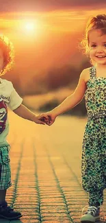 Two happy children holding hands at sunset on a scenic road.