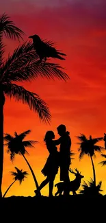 Silhouette of couple with sunset and palm trees in the background.