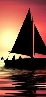 Sailboat on calm water at sunset with vibrant orange sky.