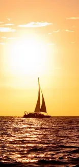 Silhouetted sailboat against a golden sunset on a calm ocean.