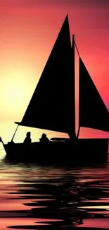 Silhouette of sailboat at sunset with vibrant orange sky.