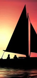 Sailboat silhouette against a vivid sunset sky wallpaper.