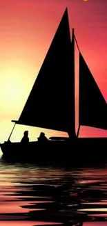 Silhouette of a sailboat at sunset on a calm ocean.