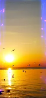 Golden sunset over ocean with birds flying.