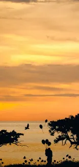 Elegant ship sails at sunset on a tranquil sea with golden sky.