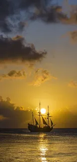 Silhouette of a ship sailing at sunset with golden sky over the ocean.