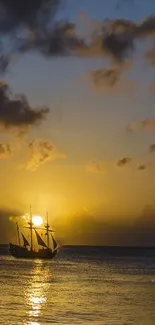 Golden sunset with a sailing ship on the tranquil sea.