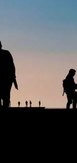 Silhouetted figures against a serene sunset sky gradient.