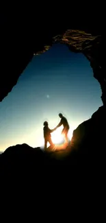 Silhouetted figures at sunset in a cave view, creating a serene mobile wallpaper.