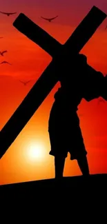 Silhouette of person carrying cross at sunset with birds.