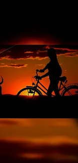 Silhouette of cyclist and dog at sunset, vivid orange sky.