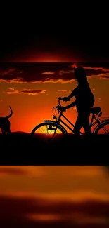 Silhouette of cyclist and dog during an orange sunset.