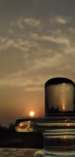 Serene sunset silhouette with glass reflection against a warm evening sky.