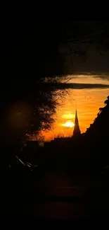 Orange sunset silhouette with urban skyline.