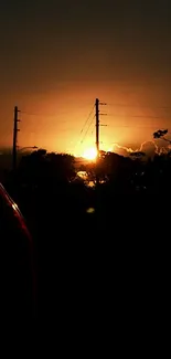 Silhouetted sunset with glowing sky and horizon.