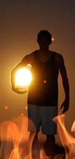 Silhouette holding the sun at sunset, creating a serene and artistic mobile wallpaper.