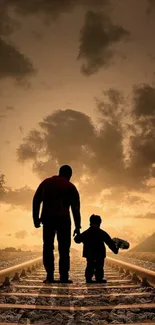 Silhouette of parent and child walking on railway tracks during sunset.