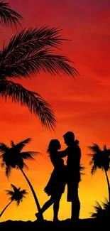 Silhouette of a couple under palm trees with a vibrant sunset background.