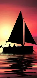 Silhouette of a sailboat on tranquil waters during a vivid pink and orange sunset.