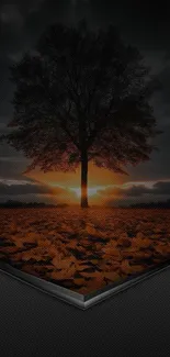 Silhouette of tree at sunset with orange sky.